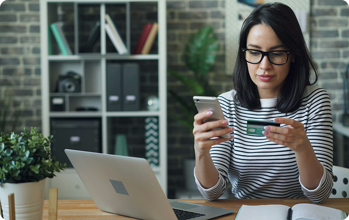 Person using a phone and card for debt consolidation